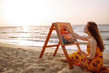 Woman painting on the beach