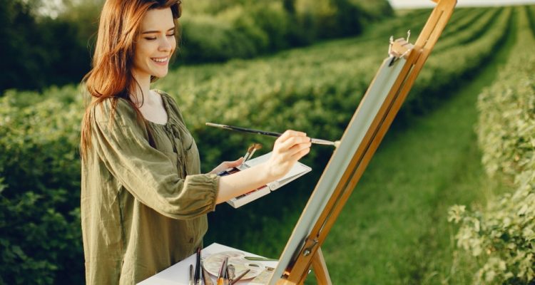 Woman painting outdoors